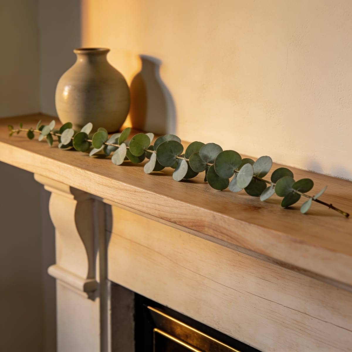 silver green eucalyptus garland along a neutral mantel