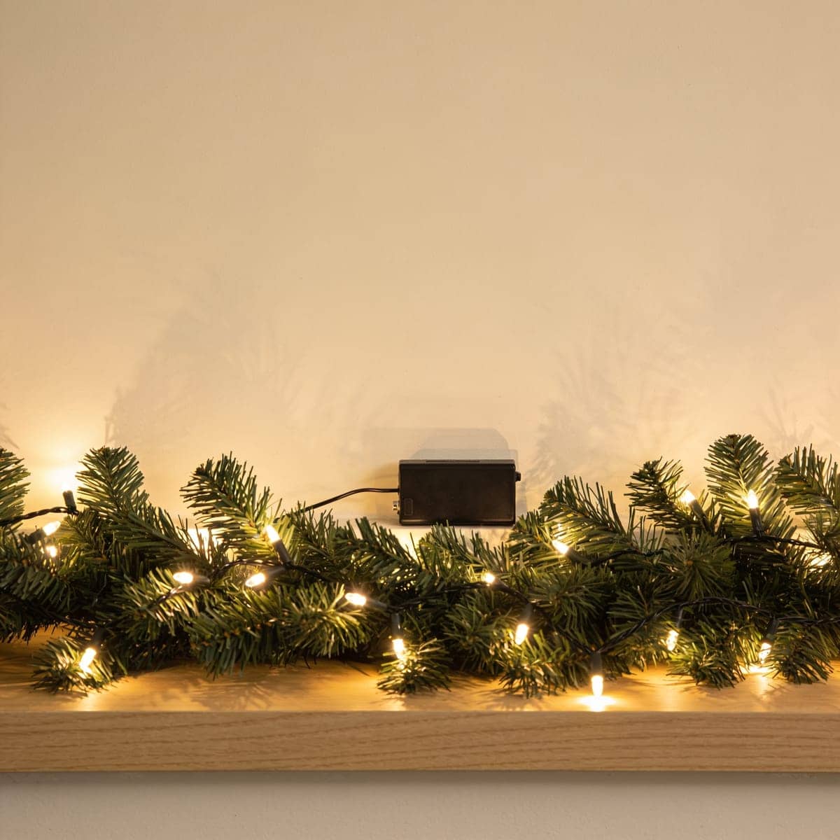 battery lit garland glowing warm on a windowsill