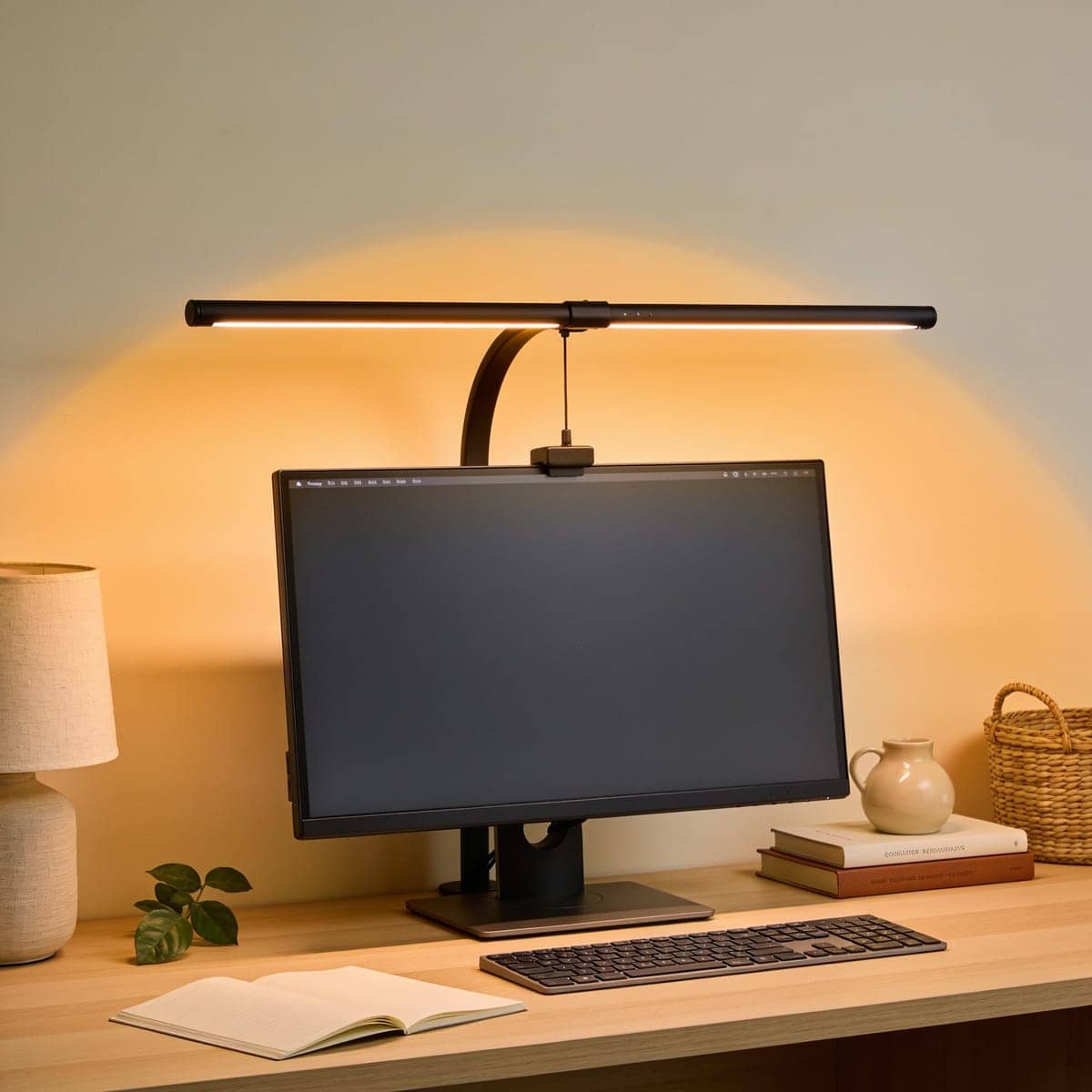slim monitor light bar resting on a screen lighting the keyboard below