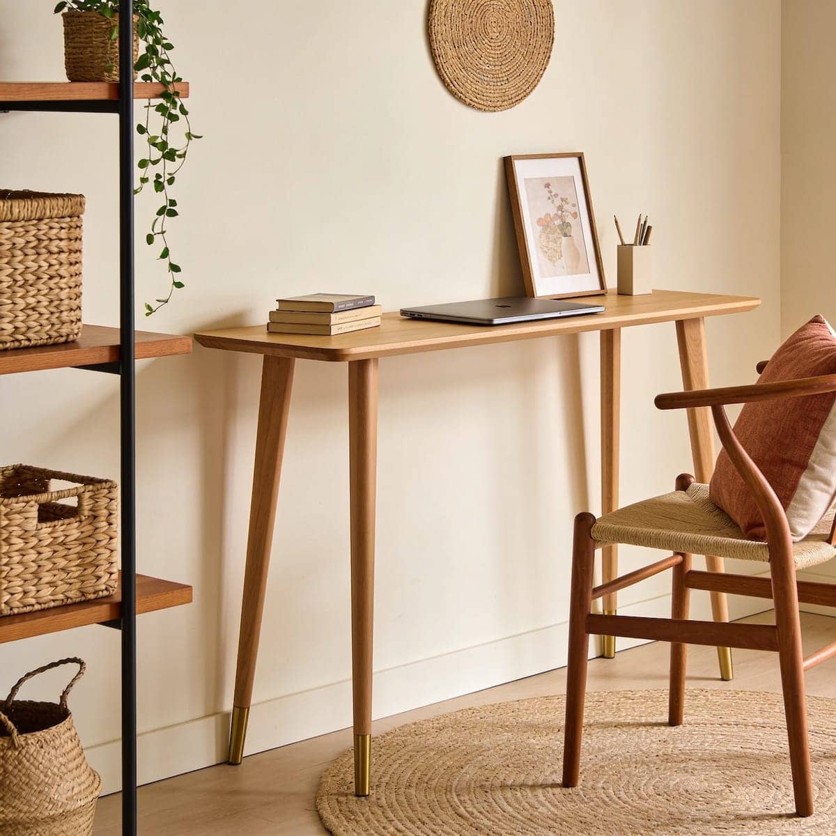 narrow console desk styled behind a sofa doubling as a work spot