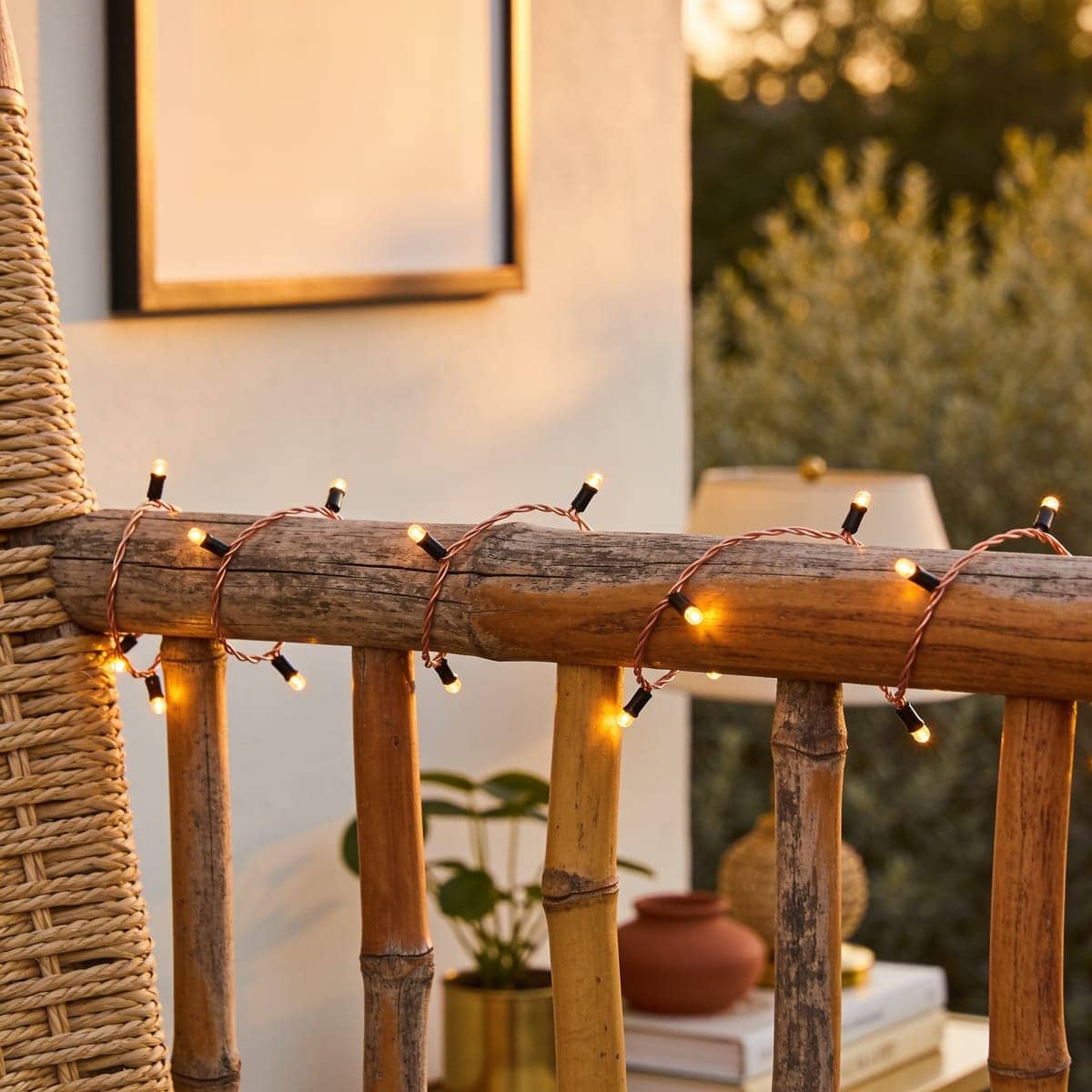 copper wire fairy lights wrapped on a railing