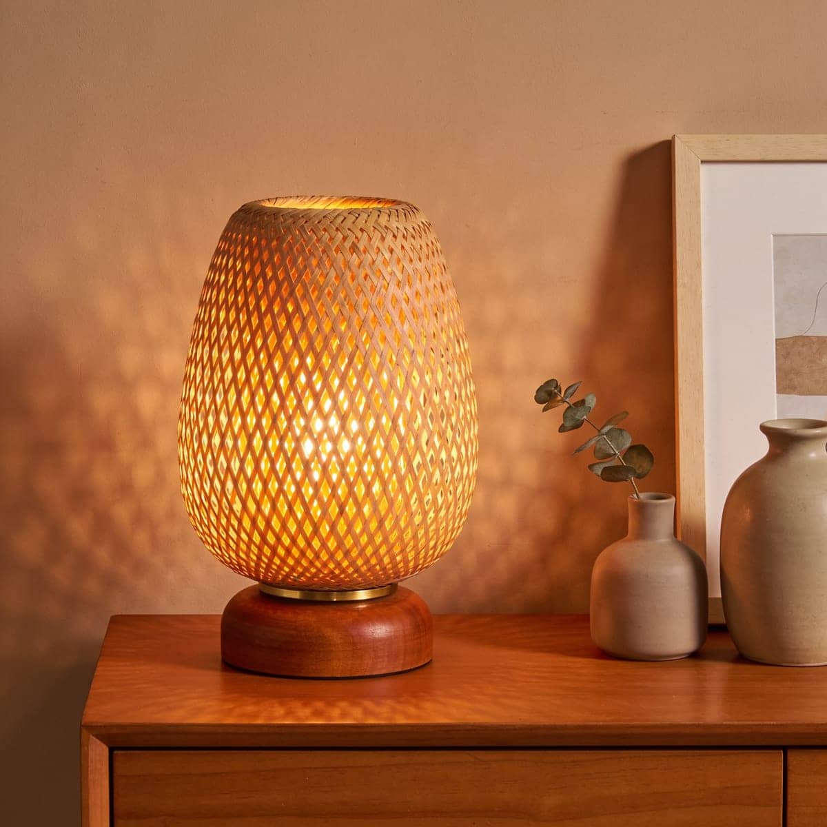 rattan woven shade table lamp casting a warm patterned glow