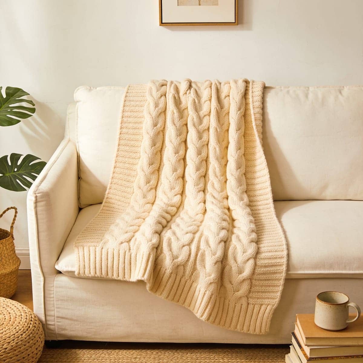 cream cable knit throw over the back of a sofa
