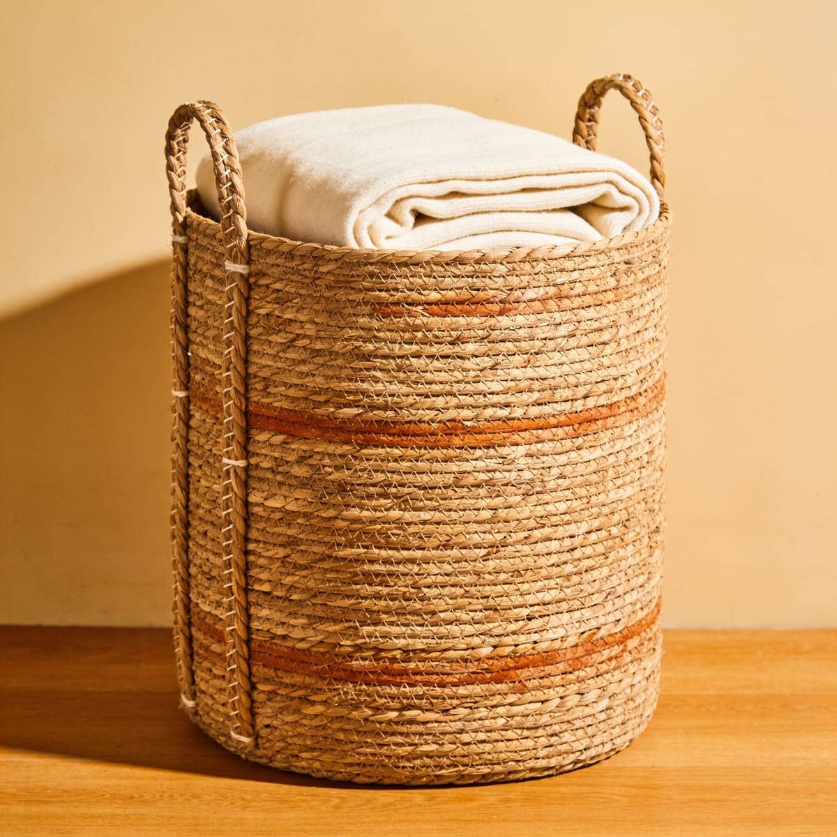 natural seagrass storage basket with handles in a living room