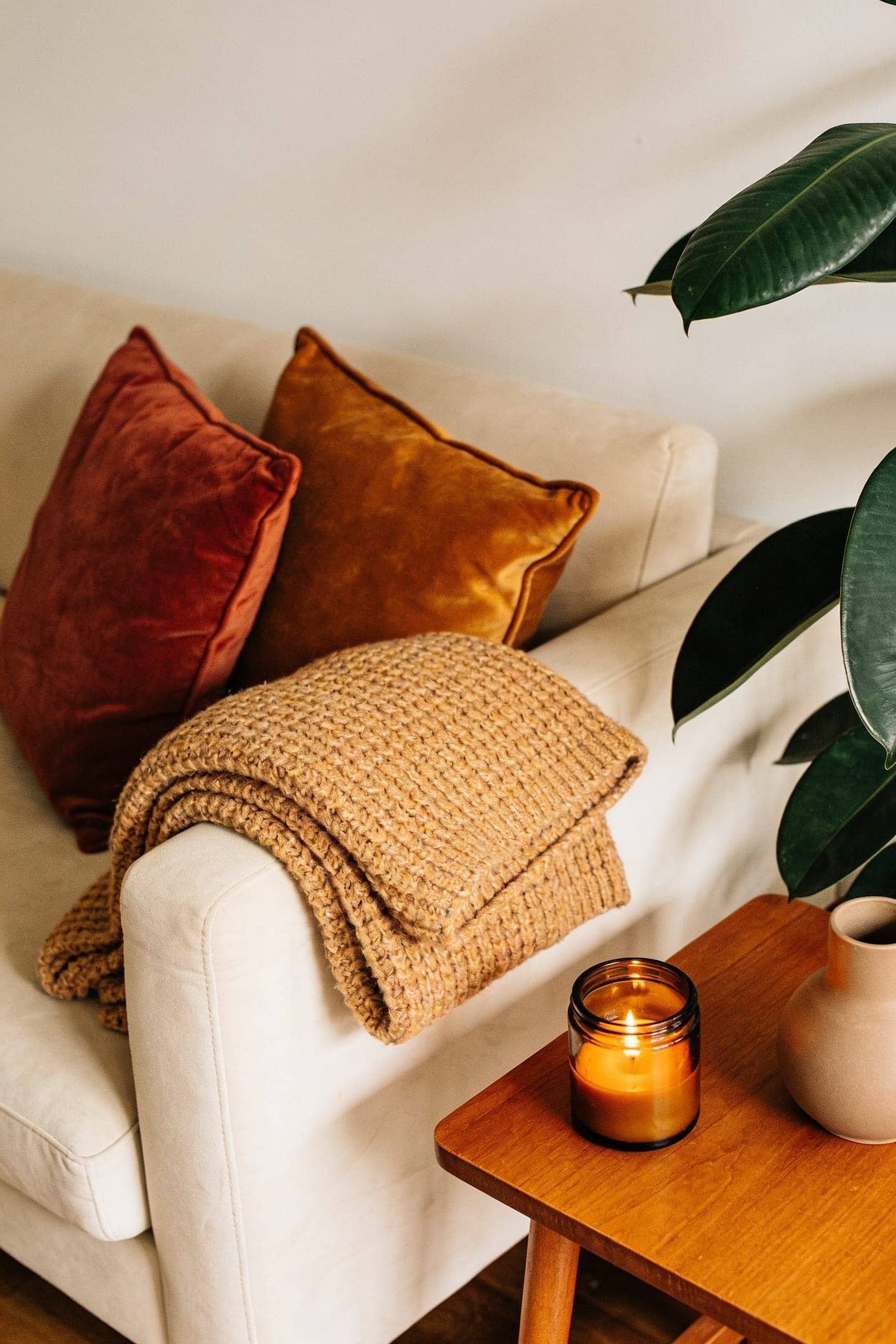 a neutral living room with a few warm fall layers added on top