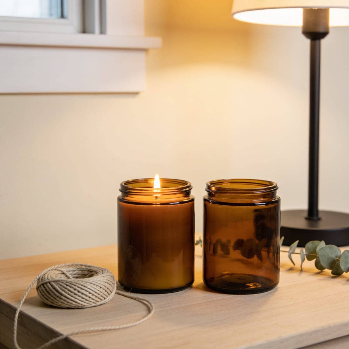 pair of amber glass jar candles tied with twine