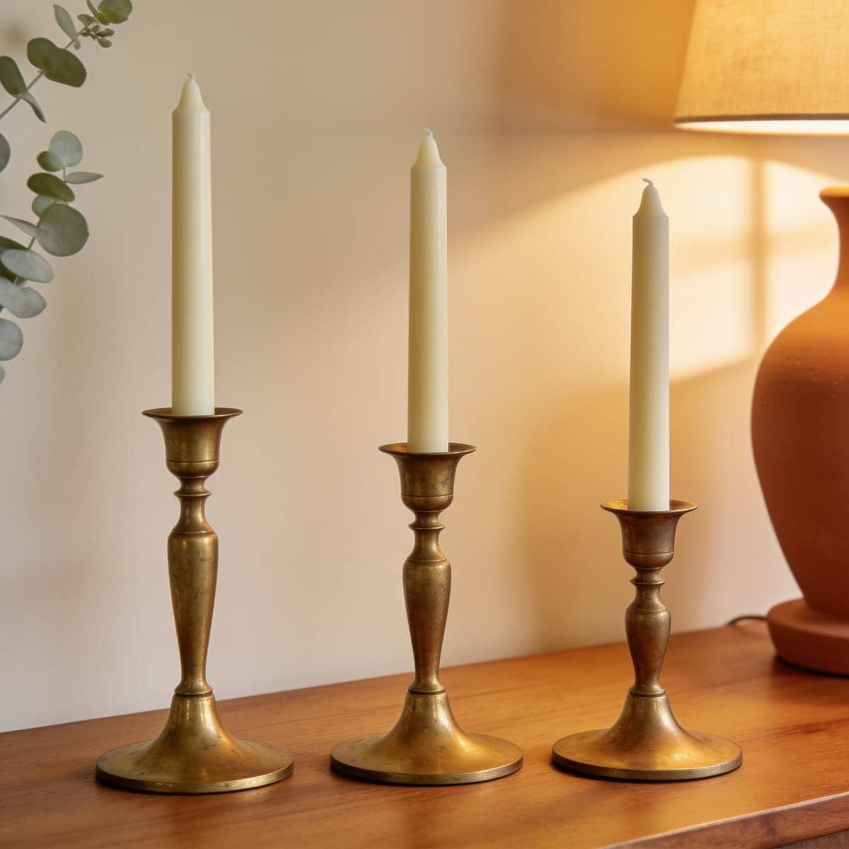 set of three brass taper candle holders at different heights