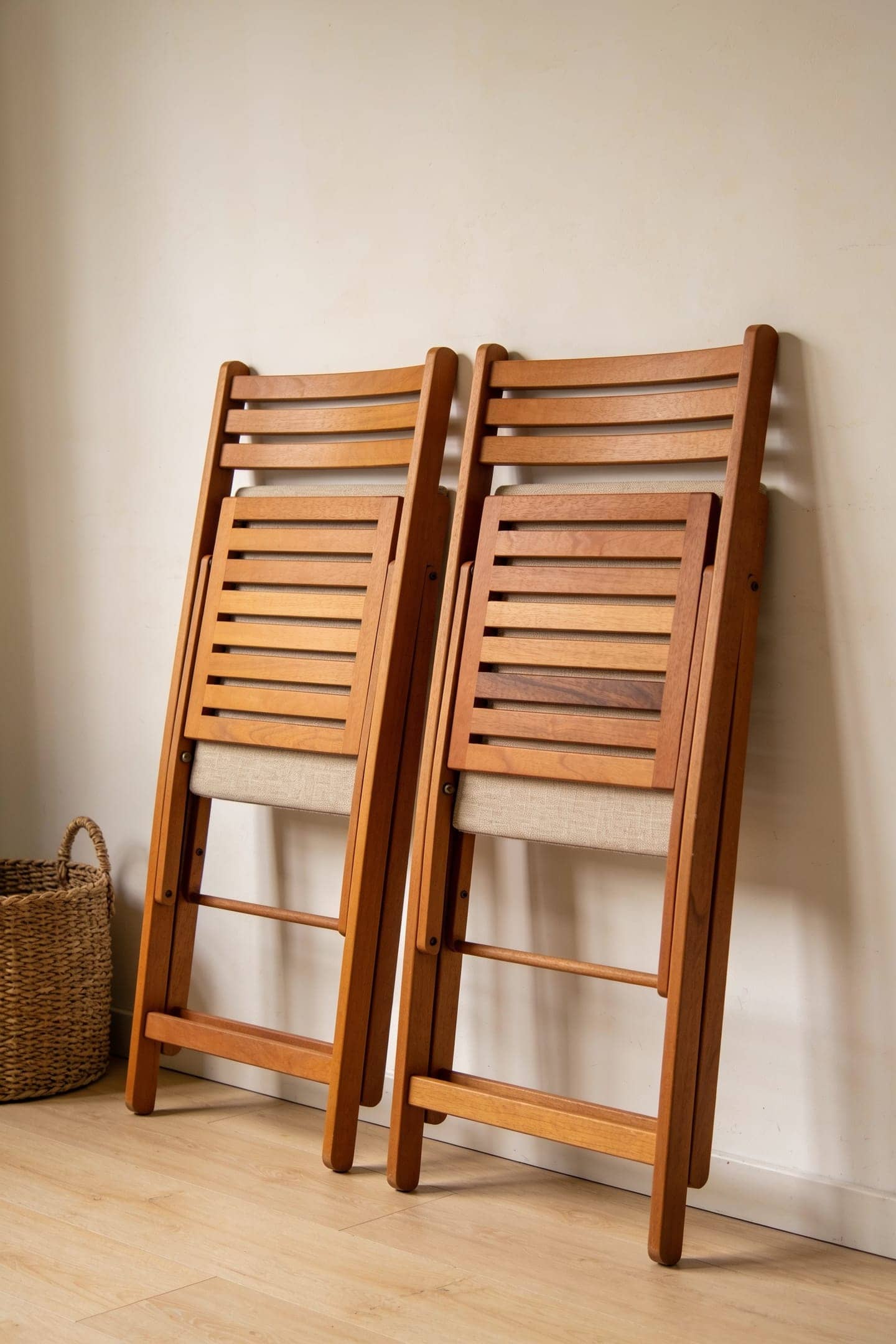 folding wood dining chairs stored flat against a closet wall
