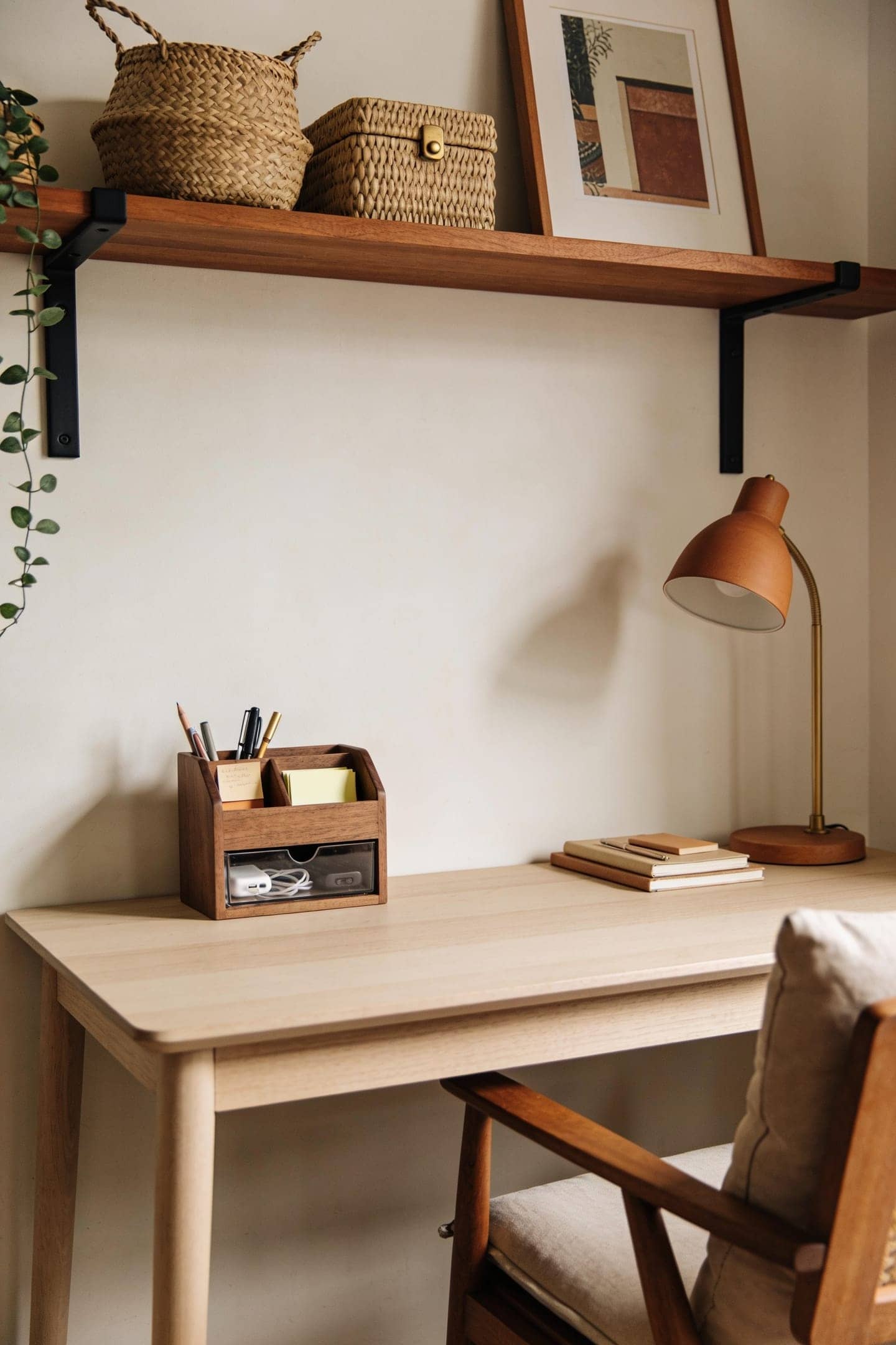 small desk with a tidy organizer holding pens and a drawer keeping the top clear